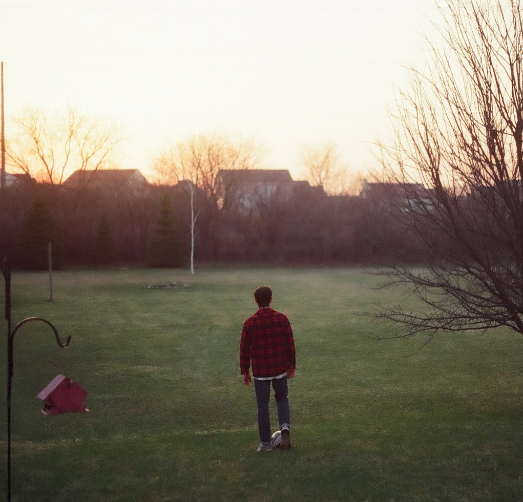 Bernard Hefner walking across a backyard at dusk